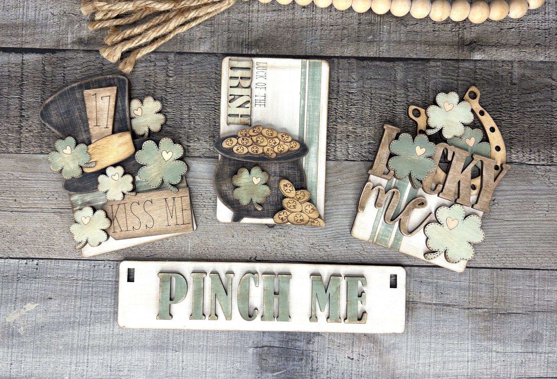 St. Patrick’s Day DIY wood sign kit with interchangeable tiered tray decor featuring shamrocks, Pinch Me plaque, Luck of the Irish sign, and March 17 design.