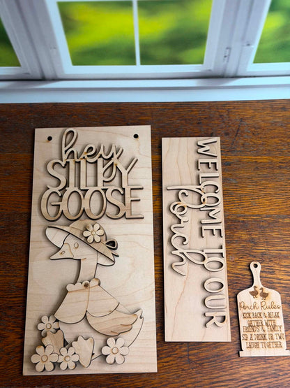 Two wooden signs with engraved text and a duck design on a wooden surface.