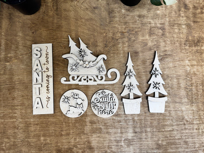 Laser-cut Santa Christmas DIY décor insert with layered sleigh, holiday signs, snowflakes and potted evergreen trees