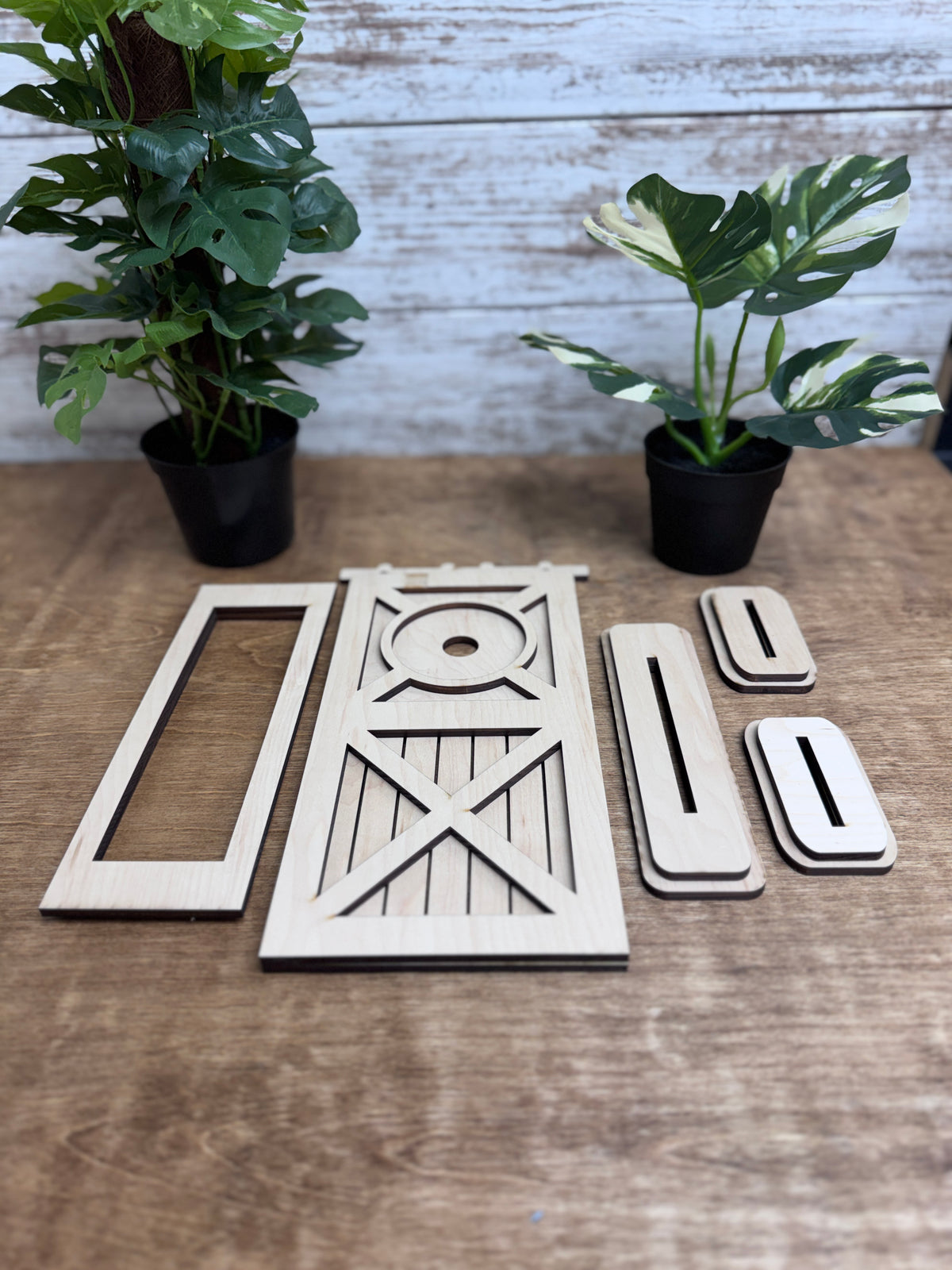 Unfinished laser-cut wood door retrofit kit pieces ready to paint and assemble