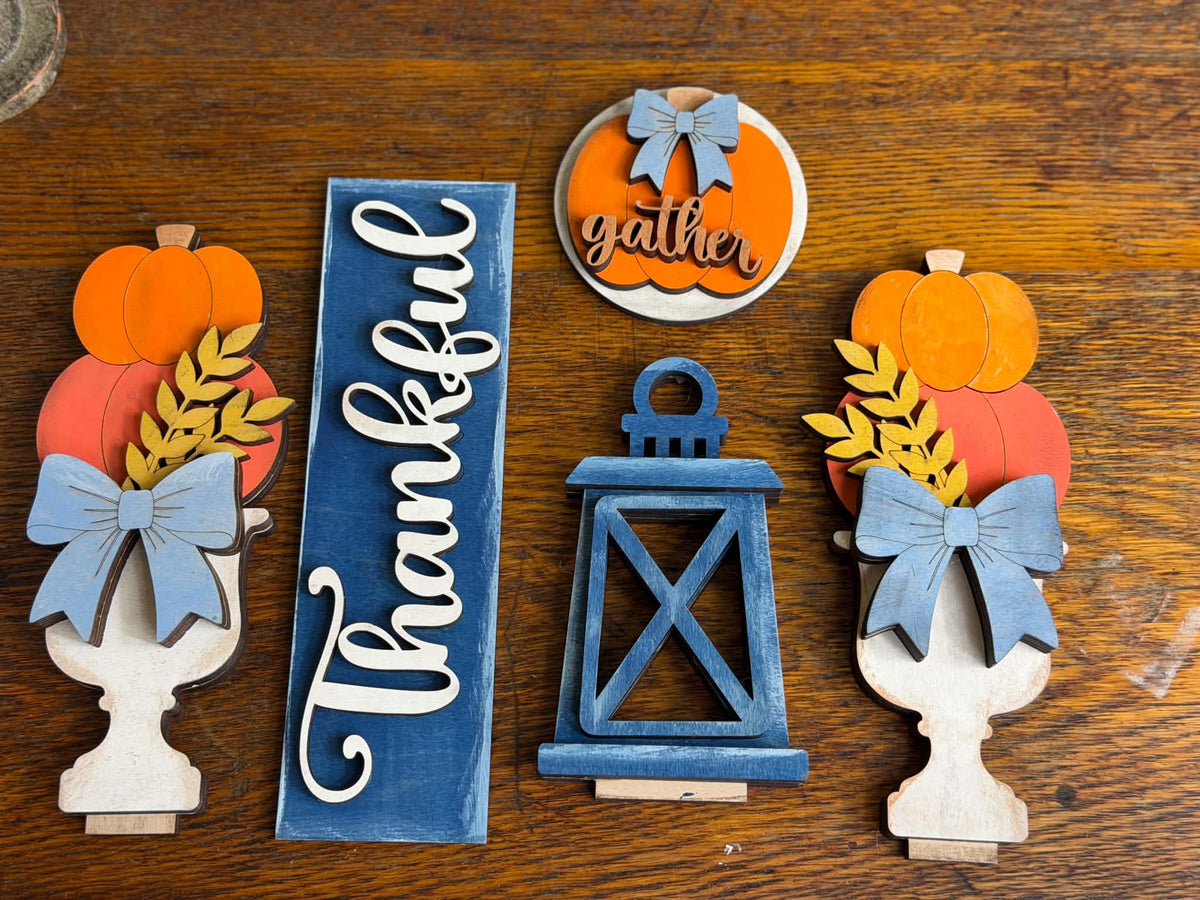 Painted Thankful fall décor pieces with pumpkins, blue bows, lantern and interchangeable Gather insert