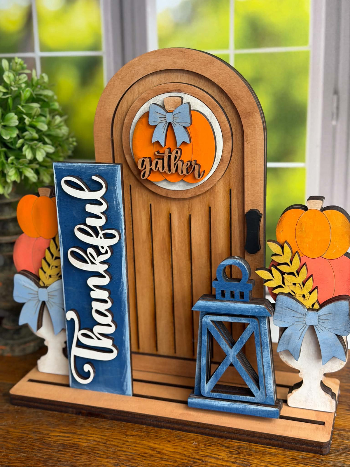 Finished Thankful fall interchangeable door display with pumpkins, lantern and Gather pumpkin insert