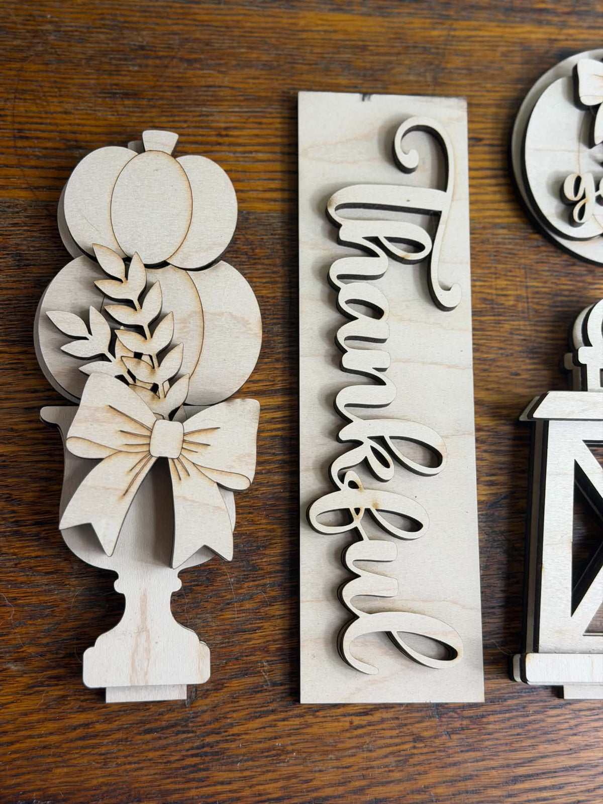 Unfinished laser-cut pumpkin topiary and Thankful sign from the fall DIY wood décor set